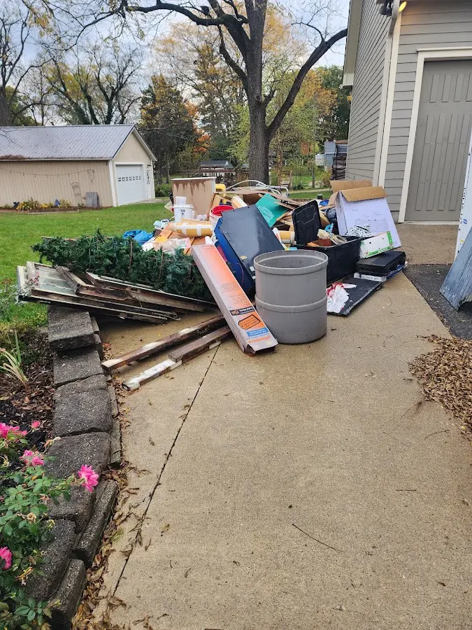 Dumpster being loaded with debris for Estate Cleanout Dumpster Rental in Chelsea